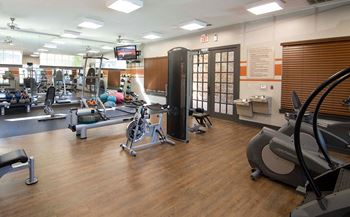 Spacious fitness center with gym equipment and machines at Overlook at Gwinnett Stadium Lawrenceville, GA